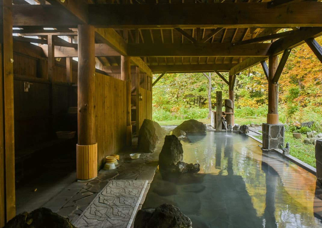 Stomige openlucht-onsen (warmwaterbron) in een ryokan in het Nyuto bos, Akita, Japan
