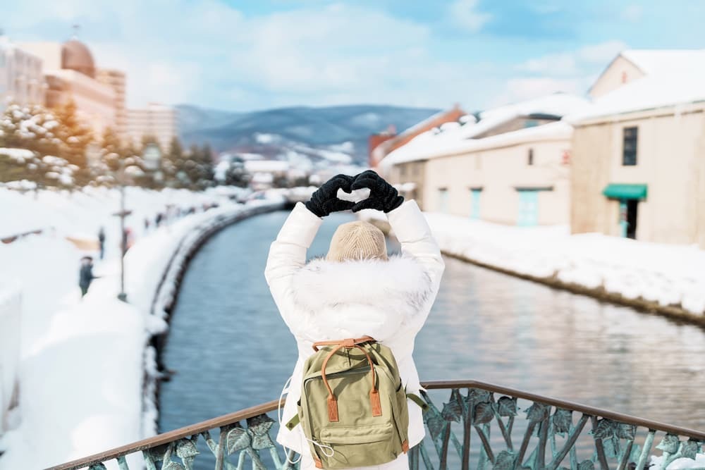 Toeristische sightseeing langs het besneeuwde Otaru-kanaal in Hokkaido, Japan, genietend van het winterseizoen