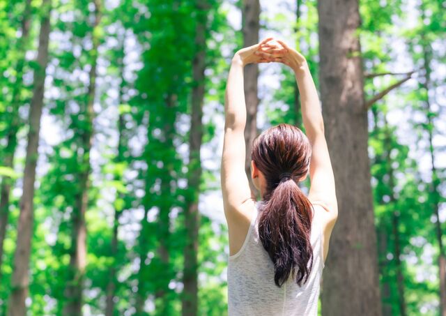 Jonge vrouw die midden in de natuur in Japan aan bosbaden doet